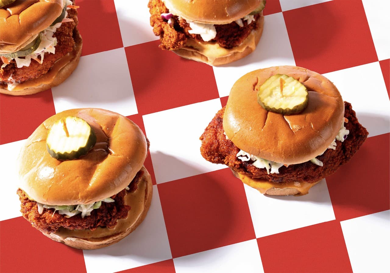 Hot chicken sandwiches with pickles on classic checkered paper
