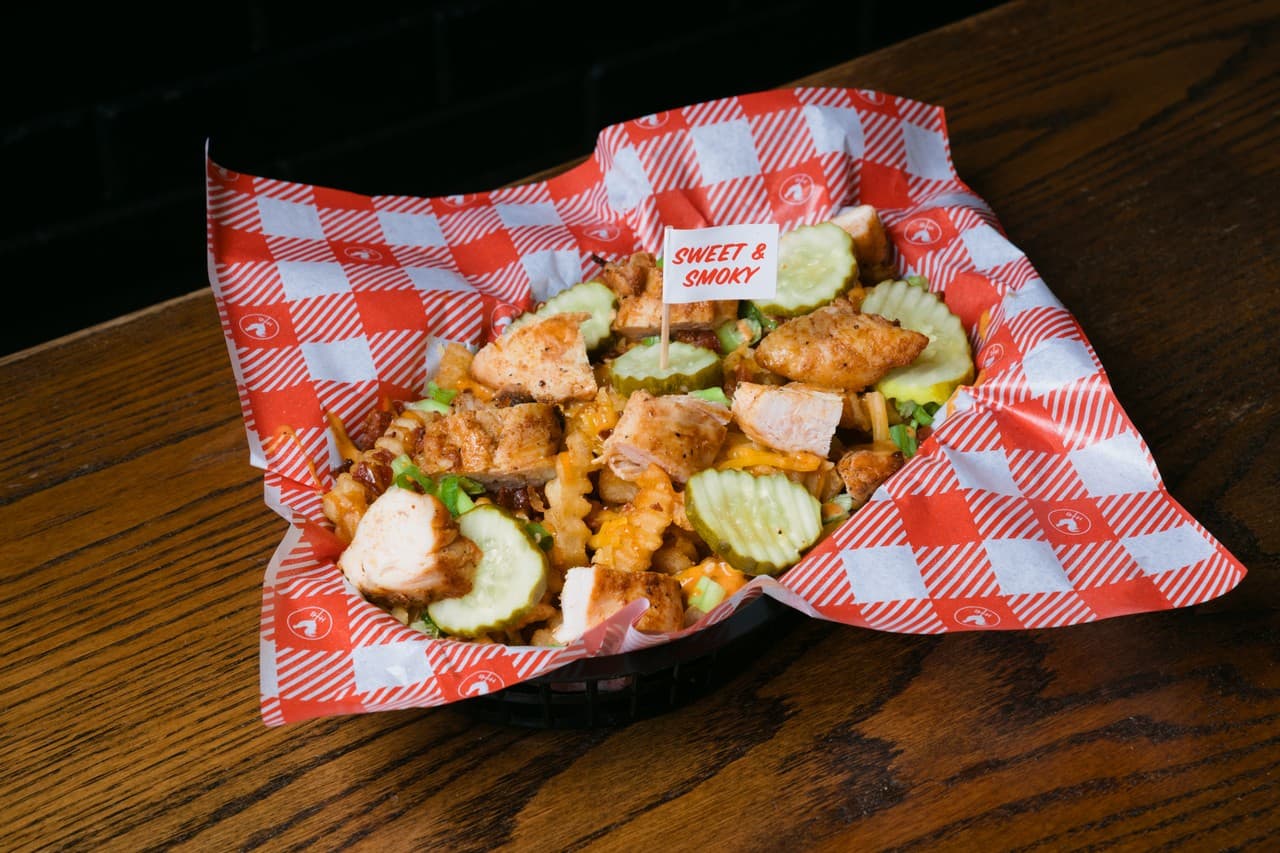 Basket of golden fried chicken bites with pickles at the restaurant